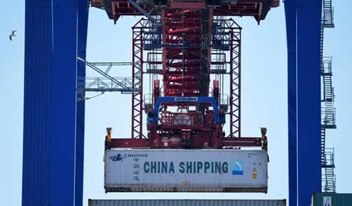 Port crane lifting a China Shipping container for export