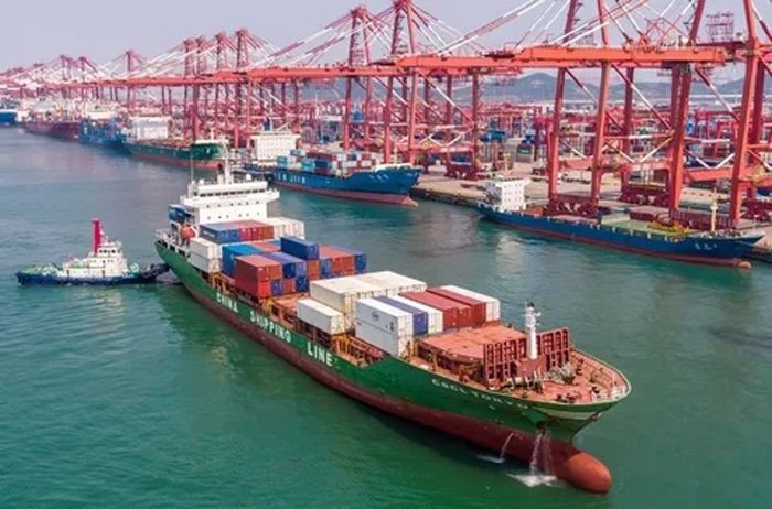 Container ship loading at a busy Chinese port for international shipping