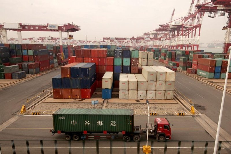 Truck transporting container at port in China for shipment to Malaysia