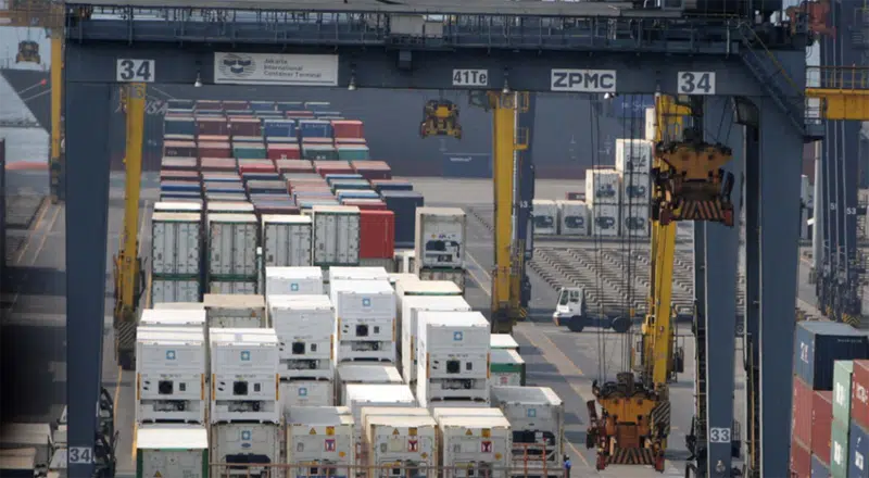 Container terminal at Jakarta port with cranes handling inbound cargo from China
